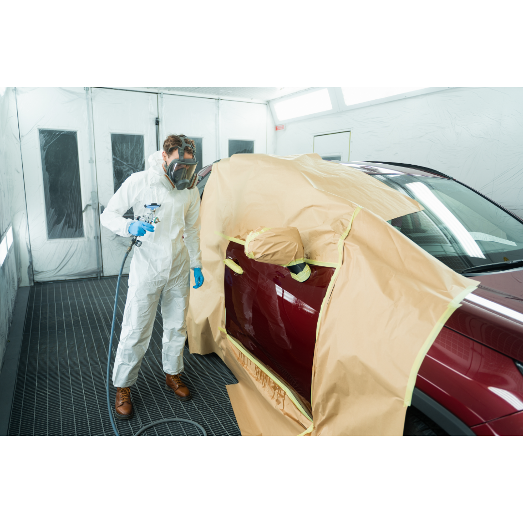 Spray painting the body of the car red